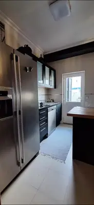 a kitchen with a large stainless steel refrigerator at Location la vue sur mer in Albufeira