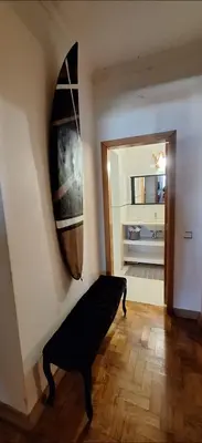 a room with a surfboard hanging on the wall at Location la vue sur mer in Albufeira