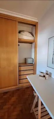 a room with a desk and a bed in a closet at Location la vue sur mer in Albufeira