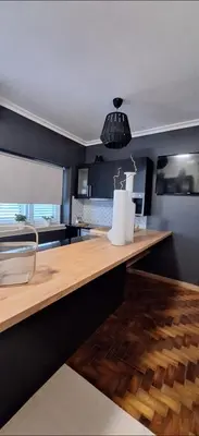 a kitchen with a wooden counter top in a room at Location la vue sur mer in Albufeira