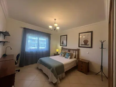 a bedroom with a bed and a window at Praia Village by Garvetur in Quarteira