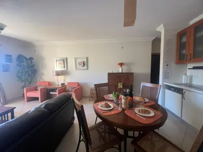a living room with a table and a couch at Praia Village by Garvetur in Quarteira