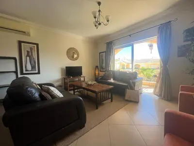 a living room with a couch and a table at Praia Village by Garvetur in Quarteira