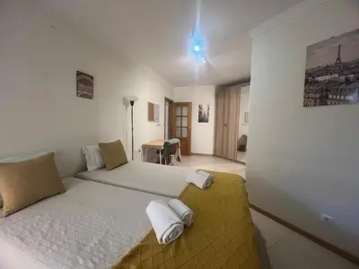a bedroom with a bed and a desk in it at Praia Village by Garvetur in Quarteira