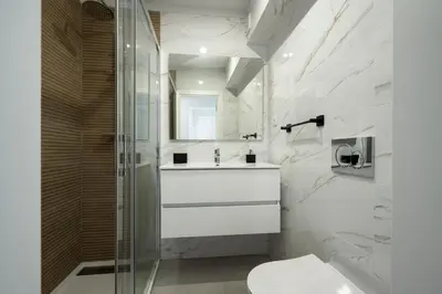a white bathroom with a sink and a shower at Casa Pereira - Guest House Faro City Center in Faro