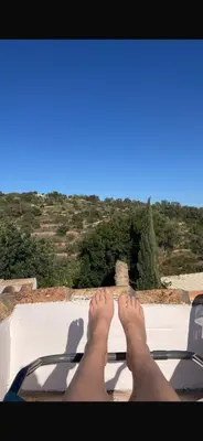 a person with their feet up on a ledge at Casa Andorinha
