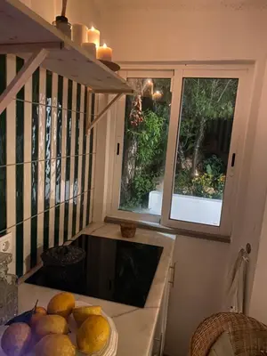 a kitchen with a bowl of fruit on a counter at Casa Andorinha