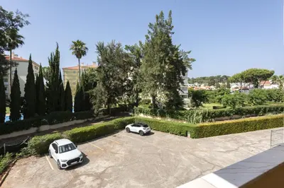 two white cars parked in a parking lot at Alva - cozy apartment with pool by HD in Vilamoura
