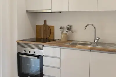 a kitchen with a sink and a stove at Alva - cozy apartment with pool by HD in Vilamoura