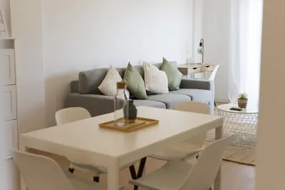 a living room with a table and a couch at Alva - cozy apartment with pool by HD in Vilamoura