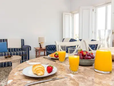 a bedroom with a bed and a desk and a window at Vilamoura Sea View Apartment by Stay ici Algarve Holiday Rental in Quarteira
