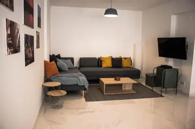 a living room with a couch and a tv at Seaside Inspire Wilderness in Quarteira