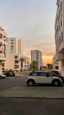 a white car parked on the side of a city street at Seaside Inspire Wilderness in Quarteira