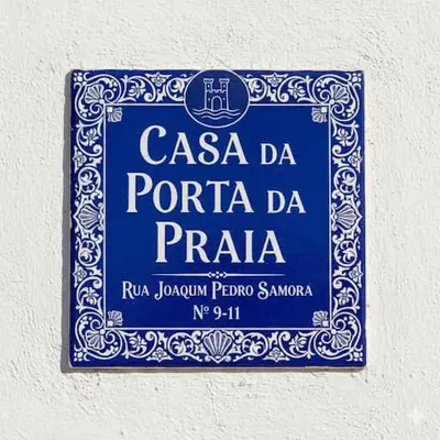 a blue sign on the side of a building at Casa da Porta da Praia - 1 Bedroom Castle Wall Loft in Albufeira