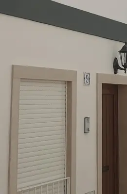 a garage door in a room with a number on the wall at Casa da Porta da Praia - 1 Bedroom Castle Wall Loft in Albufeira