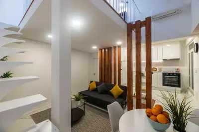 a living room with a couch and a table at Casa da Porta da Praia - 1 Bedroom Castle Wall Loft in Albufeira