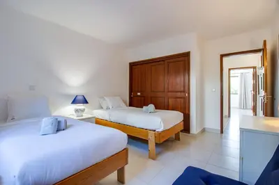 a bedroom with two beds and a table with a lamp at Relaxing 2BD Apt 500m Beach w AC WiFi Pool in Albufeira