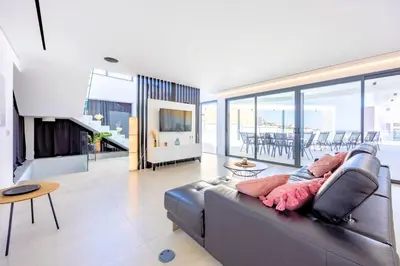 a living room with a couch and a table at Villa Vista Albufeira Sea Views Heated Pool Walk To Marina in Albufeira