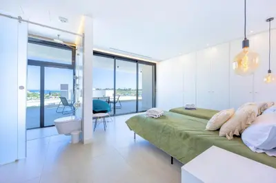 a bedroom with a bed and a view of the ocean at Villa Vista Albufeira Sea Views Heated Pool Walk To Marina in Albufeira