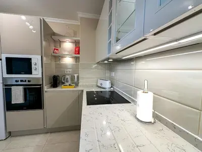a kitchen with white counter tops and appliances at Vilamoura View Apartment in Quarteira