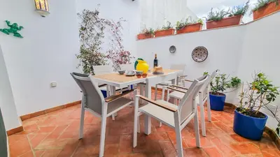 a dining room table with a yellow vase and glasses at Blue Haven By The Ria - Faro City in Faro