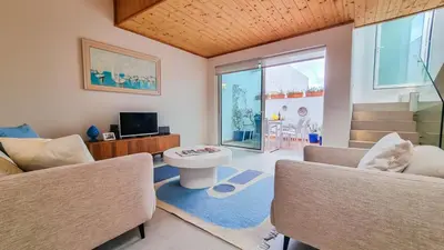 a living room with a couch and chairs and a tv at Blue Haven By The Ria - Faro City in Faro