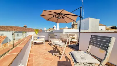 a balcony with a potted plant and a table and chairs at Blue Haven By The Ria - Faro City in Faro