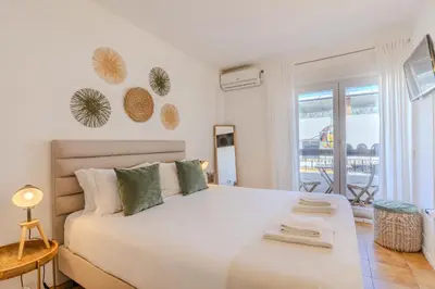 a bedroom with a large white bed and a balcony at #347 Albufeira Dream Home by Home Holidays in Albufeira