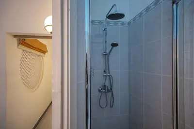 a bathroom with a shower with a glass door at Villa Lina - Vilamoura in Quarteira
