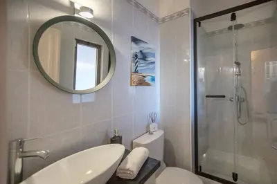 a bathroom with a toilet and a sink and a mirror at Villa Lina - Vilamoura in Quarteira