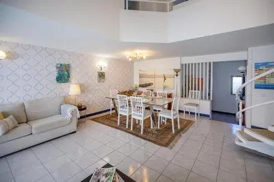 a living room with a couch and a table and chairs at Villa Lina - Vilamoura in Quarteira