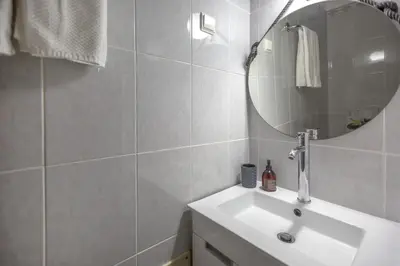 a bathroom with a sink and a mirror at Villa Lina - Vilamoura in Quarteira