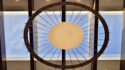 a large wooden fan in front of a window at Villa Albatros Cleverdetails, Vilamoura, private pool and jacuzzi in Vilamoura