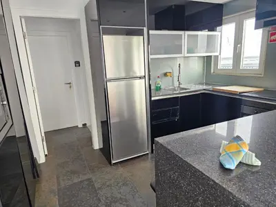 a kitchen with a stainless steel refrigerator at Blife Charlya private rooms at Faro beach in FAO
