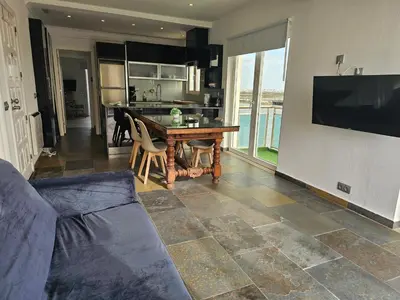 a living room with a couch and a table at Blife Charlya private rooms at Faro beach in FAO
