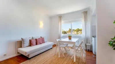 a living room with a couch and a table at Studio 54 by Sunnyway in Albufeira