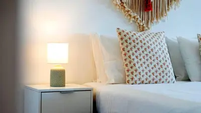a bedroom with a bed and a lamp on a night stand at Studio 54 by Sunnyway in Albufeira