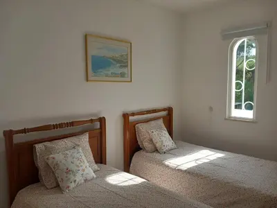 a bedroom with two beds next to a window at Vilamoura Pinhal Golf Course in Quarteira