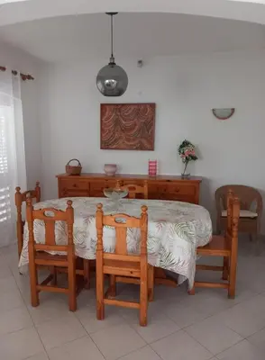 a dining room with a table and two chairs at Vilamoura Pinhal Golf Course in Quarteira
