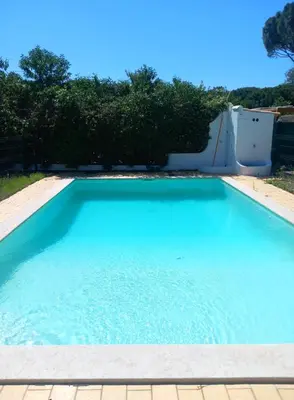 a large blue swimming pool in a yard at Vilamoura Pinhal Golf Course in Quarteira