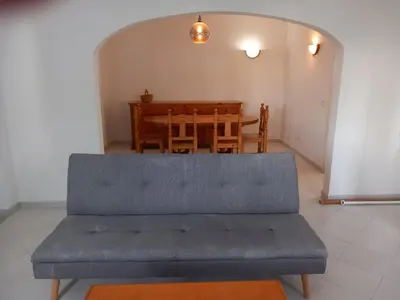 a couch in a living room with a table at Vilamoura Pinhal Golf Course in Quarteira