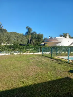 a fence in front of a field of grass at Vilamoura Pinhal Golf Course in Quarteira