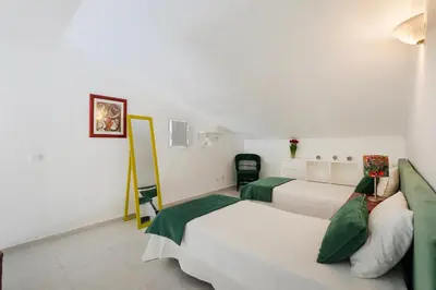 a balcony of a house with two chairs at Casa Sol Dourado in Albufeira