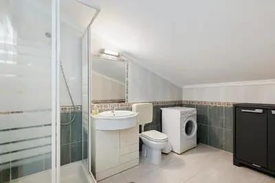 a white bathroom with a washing machine and a sink at Casa Sol Dourado in Albufeira