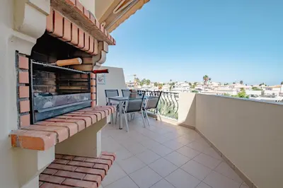 a balcony with a table and chairs on a building at Condo-Pool walk to the Beach by Algarve Dream Holidays in Albufeira