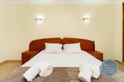 a bedroom with a bed with two towels on it at Albufeira Breeze Living - Dream Lodging in Albufeira