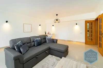 a living room with a gray couch in a room at Albufeira Breeze Living - Dream Lodging in Albufeira