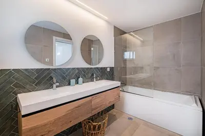 a bathroom with a sink and a tub and a mirror at Casa Joaninha - Heated pool - Algarve in Algoz