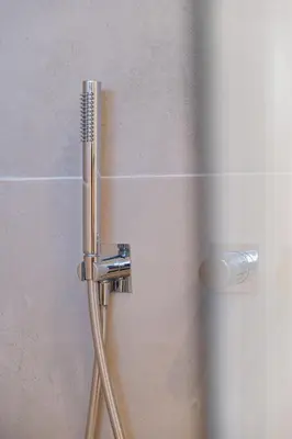 a shower with a chrome shower head in a bathroom at Casa Joaninha - Heated pool - Algarve in Algoz