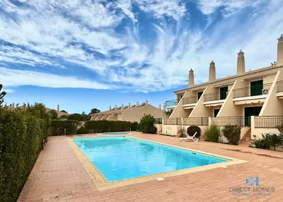 a swimming pool in front of a house at Villa Rosal 21 in Albufeira
